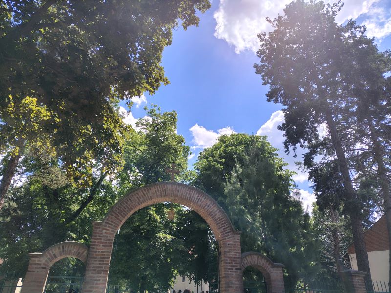 Ulaz u portu pravoslavne crkve sa krstom na svodu iznad kapije.